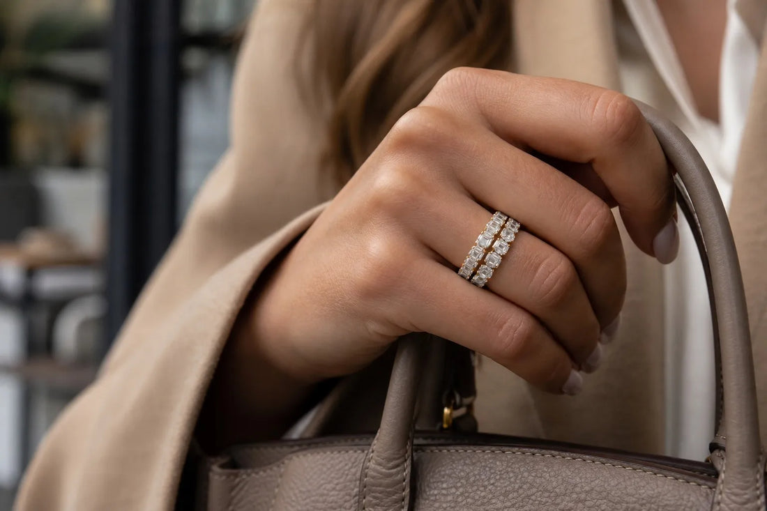 Lifestyle image of a hand wearing stacked lab diamond eternity bands